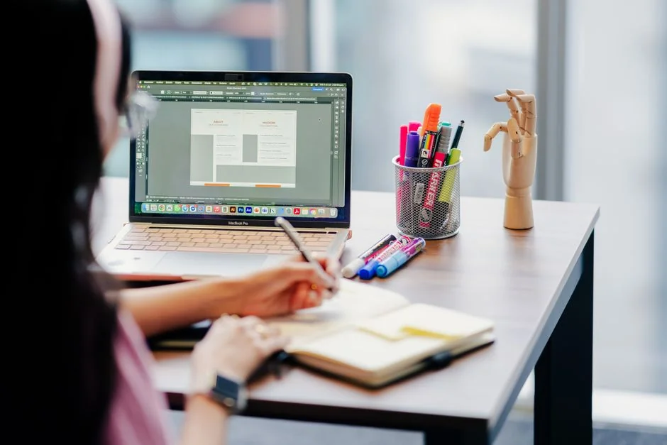 A sleek computer display showing web design work, highlighting creative visuals in a workspace.