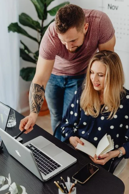 A person using a laptop to browse stock photo websites. Freelancing work in a cozy setting.